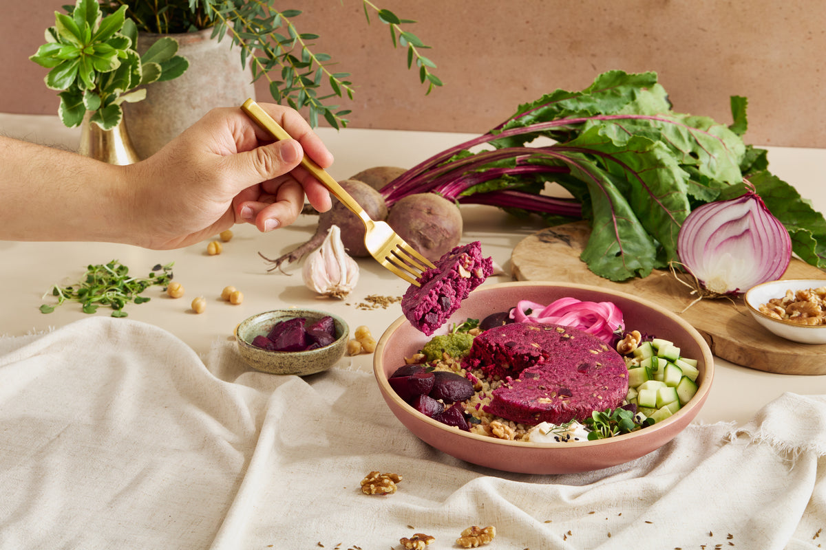 Beet and walnut patty bowl with fresh vegetables and whole ingredients